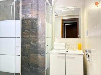 a white bathroom with a sink and a shower at Mar de Viya Grupo AC Gestion in Cádiz