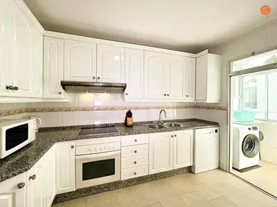 a kitchen with white cabinets and a sink and a dishwasher at Mar de Viya Grupo AC Gestion in Cádiz