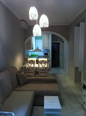 a living room with a couch and a table at Casa Palacio en Casco Antiguo in El Puerto de Santa María