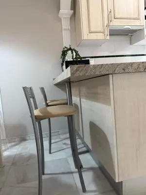 a kitchen with a counter and two stools at Casa Palacio en Casco Antiguo in El Puerto de Santa María