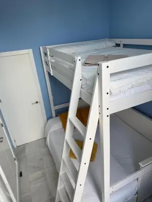 two bunk beds in a room with a blue wall at Casa Palacio en Casco Antiguo in El Puerto de Santa María