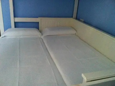 a small bedroom with two beds in it at Casa Palacio en Casco Antiguo in El Puerto de Santa María