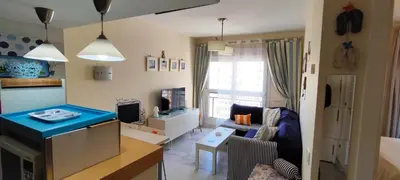 a living room with a couch and a table at MasApartamentos El Puerto in El Puerto de Santa María