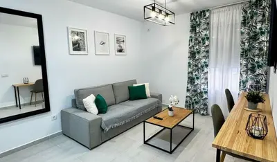 a living room with a couch and a table at Apartamentos Muñoz Fornell 4 in Chiclana de la Frontera