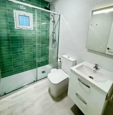 a bathroom with a toilet and a shower and a sink at Apartamentos Muñoz Fornell 4 in Chiclana de la Frontera