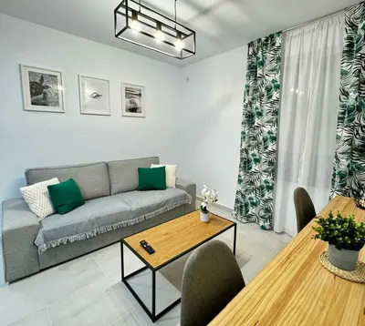 a living room with a couch and a table at Apartamentos Muñoz Fornell 4 in Chiclana de la Frontera