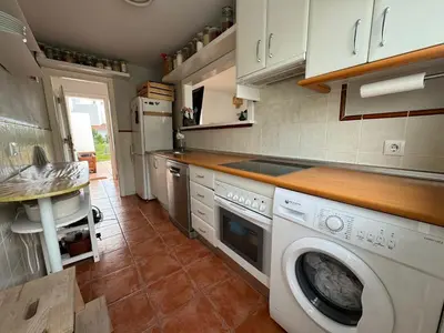 a kitchen with a washer and dryer in it at Adosado en Novo Sancti Petri in Novo Sancti Petri