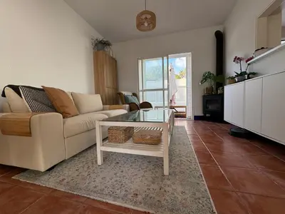 a living room with a couch and a table at Adosado en Novo Sancti Petri in Novo Sancti Petri