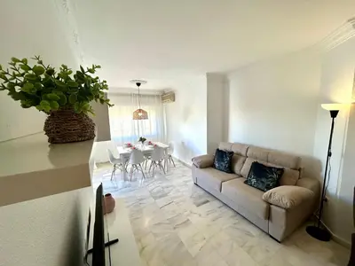 a living room with a couch and a table at Gatu VILLA ANTILLAS parking gratis preferentemente mayores de 25 años y familias in El Puerto de Santa María