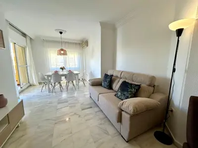 a living room with a couch and a table at Gatu VILLA ANTILLAS parking gratis preferentemente mayores de 25 años y familias in El Puerto de Santa María
