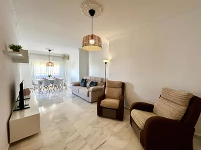 a living room with a couch and chairs and a table at Gatu VILLA ANTILLAS parking gratis preferentemente mayores de 25 años y familias in El Puerto de Santa María