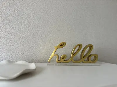 a gold sign that says hello on a table at Casa Luada in Sanlúcar de Barrameda