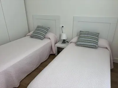 two beds sitting next to each other in a room at Casa Luada in Sanlúcar de Barrameda