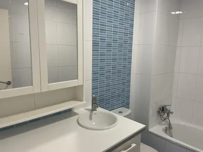 a bathroom with a sink and a toilet and a mirror at Casa Luada in Sanlúcar de Barrameda