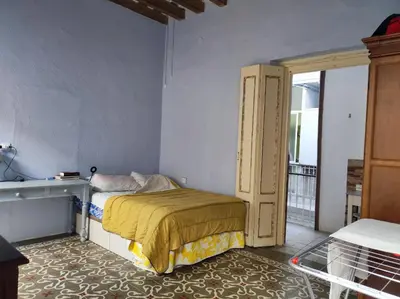 a small bedroom with a bed and a window at Old Merchant's Home in Cádiz