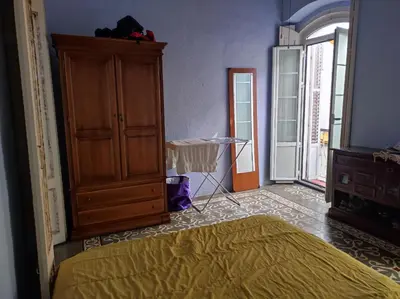 a bedroom with a bed and a dresser and a closet at Old Merchant's Home in Cádiz