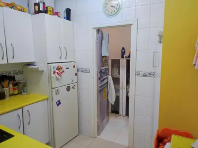 a kitchen with white cabinets and a refrigerator at Old Merchant's Home in Cádiz