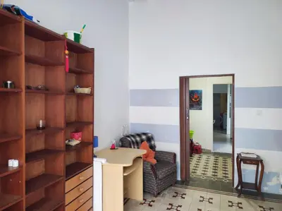 a living room with a table and a chair and a mirror at Old Merchant's Home in Cádiz