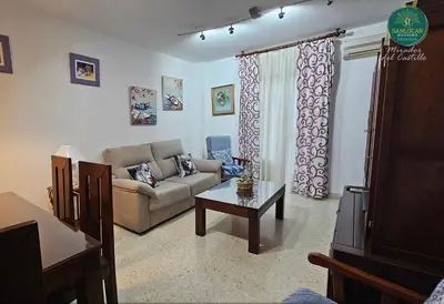 a living room with a couch and a table at Mirador del Castillo by Sanlúcar Housing in Sanlúcar de Barrameda