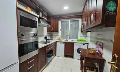 a kitchen with a sink and a stove top oven at Mirador del Castillo by Sanlúcar Housing in Sanlúcar de Barrameda