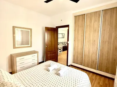 a bedroom with a bed and a dresser at Los 3 hermanos by Staycare in Rota