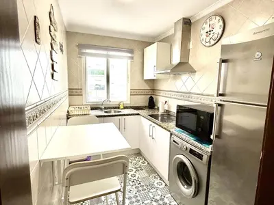 a kitchen with a refrigerator and a washer and dryer at Los 3 hermanos by Staycare in Rota