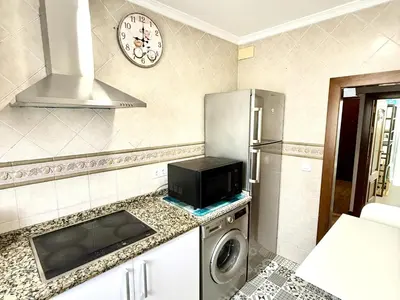 a kitchen with a refrigerator and a microwave at Los 3 hermanos by Staycare in Rota