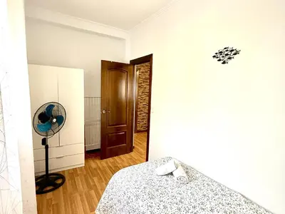a bedroom with a bed and a fan at Los 3 hermanos by Staycare in Rota