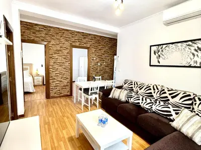 a living room with a couch and a table at Los 3 hermanos by Staycare in Rota