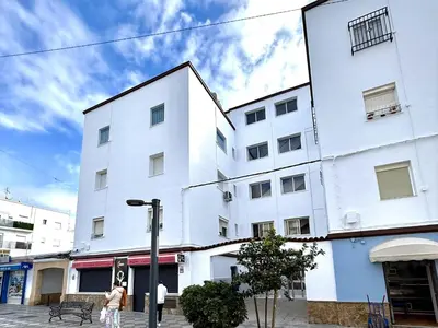 a white building with people walking in front of it at Los 3 hermanos by Staycare in Rota