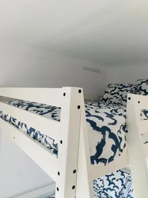a bedroom with two bunk beds with blue and white at Chipiona Center in Chipiona
