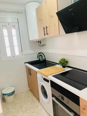 a kitchen with a sink and a washing machine at Chipiona Center in Chipiona