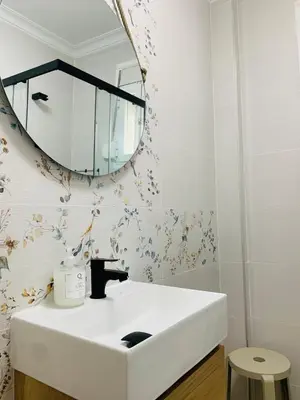 a bathroom with a white sink and a mirror at Chipiona Center in Chipiona
