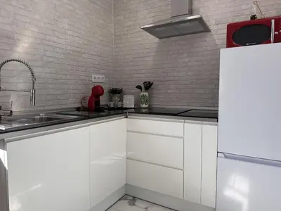 a white kitchen with a sink and a refrigerator at Dante Suite - Ole Solutions in Jerez de la Frontera