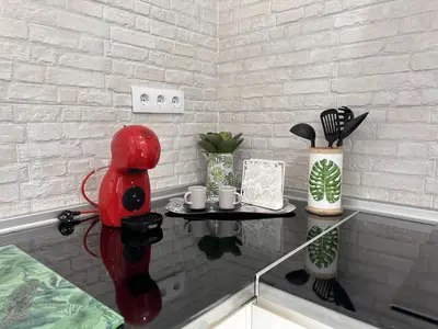 a glass table with a red figure on top of it at Dante Suite - Ole Solutions in Jerez de la Frontera