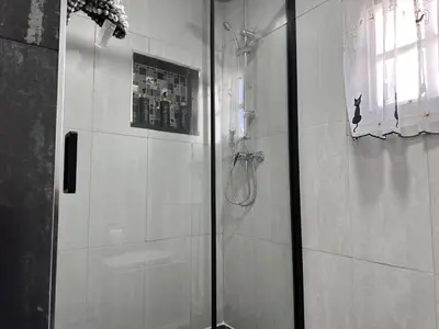 a shower with a glass door in a bathroom at Dante Suite - Ole Solutions in Jerez de la Frontera