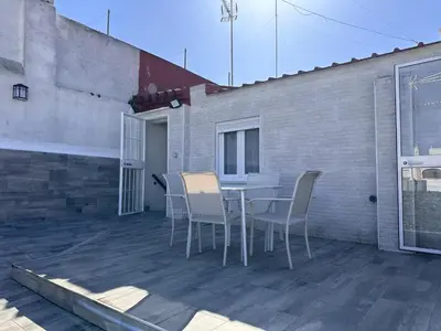 a patio with a table and chairs on a balcony at Dante Suite - Ole Solutions in Jerez de la Frontera