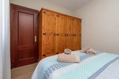 a bedroom with a bed with towels on it at Apartamento Turístico en Chiclana de la Frontera in Chiclana de la Frontera