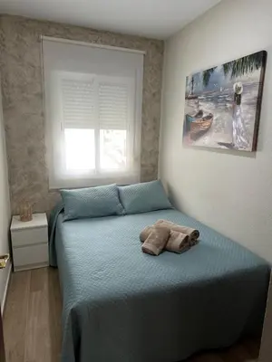 a bedroom with a bed with two towels on it at Apartamento Turístico en Chiclana de la Frontera in Chiclana de la Frontera