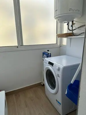 a washing machine in a room with a window at Apartamento Turístico en Chiclana de la Frontera in Chiclana de la Frontera