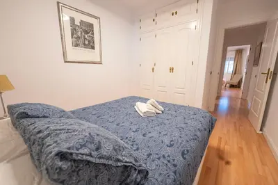 a bedroom with a bed with two towels on it at Alta Mar Playa Victoria in Cádiz