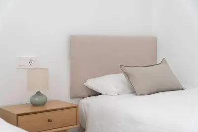 a bedroom with a bed and a nightstand with a lamp at Apartoyou - El Patio Centro in El Puerto de Santa María