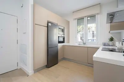 a kitchen with a stainless steel refrigerator and a counter at Apartoyou - El Patio Centro in El Puerto de Santa María