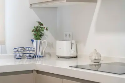 a kitchen with blue and white vases and a toaster at Apartoyou - El Patio Centro in El Puerto de Santa María