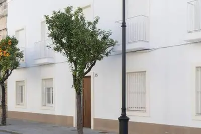 a tree in front of a white building at Apartoyou - El Patio Centro in El Puerto de Santa María