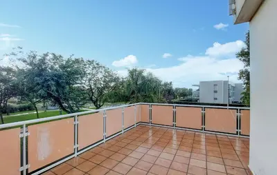 a balcony with a view of a park at 4 Bedroom Awesome Apartment In Chipiona in Chipiona