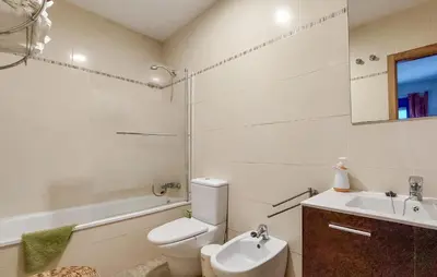 a white bathroom with a toilet and a sink at 4 Bedroom Awesome Apartment In Chipiona in Chipiona