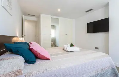 a bedroom with a large bed with pillows on it at Apartments Vistas Mar Bahia in Cádiz