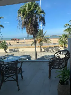 a patio with a table and chairs and a view of the beach at Arenas de Doñana in Sanlúcar de Barrameda