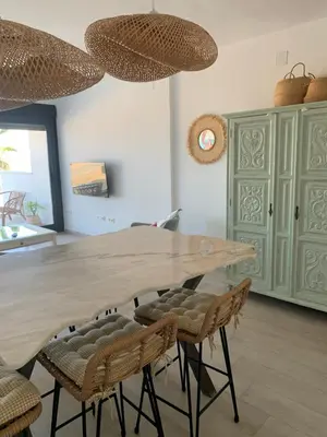 a dining room with a wooden table and chairs at Arenas de Doñana in Sanlúcar de Barrameda